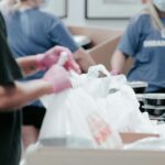 Volunteers packing donation boxes or school supplies