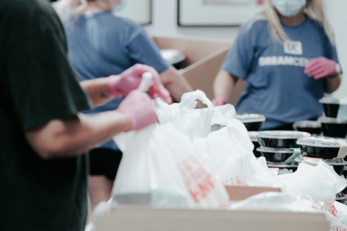 Volunteers packing donation boxes or school supplies