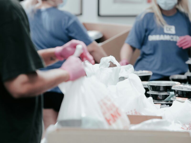 Volunteers packing donation boxes or school supplies