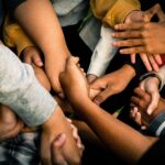 Close-up of hands helping or supporting one anothe