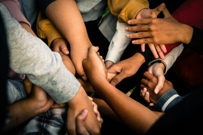 Close-up of hands helping or supporting one anothe