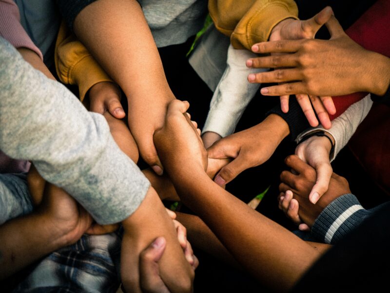 Close-up of hands helping or supporting one anothe