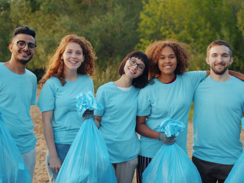 Large group of diverse community volunteers standing together